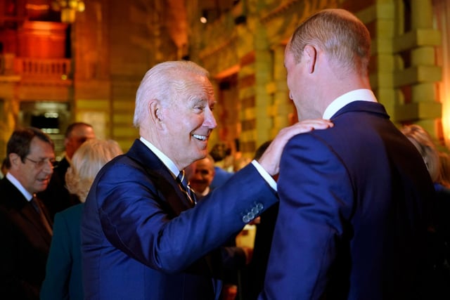 US President Joe Biden (C) greets Britain's Prince William, Duke of Cambridge (R).
