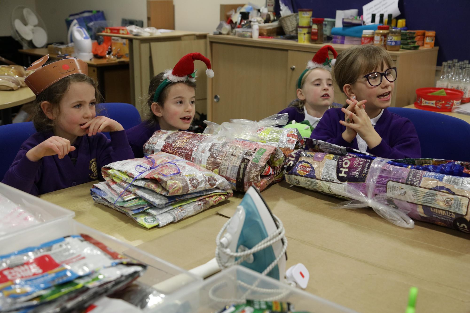 Alana Buckmaster, Sophia and Arabella Lipscomb and Natalia Hardingham learning how to make crisp packet blankets