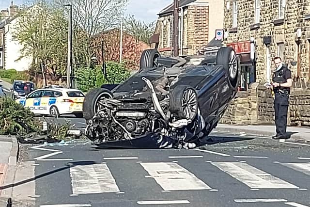 A car landed on its roof in a crash in Woodhouse, Sheffield, yesterday (Photo: JON MATTHEWS)