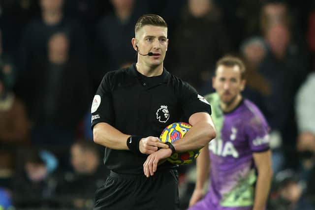 Robert Jones, Match Referee gestures towards his watch during the Premier League match between Watford and Tottenham Hotspur