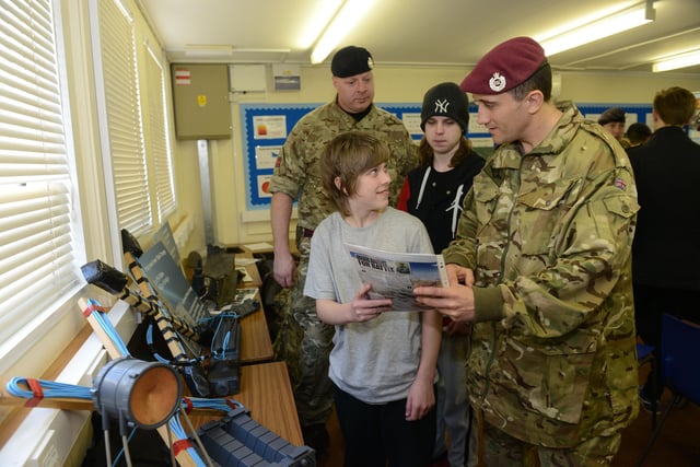 Sgt.Rob Shovlar (back left) and Cpl. Micky Mooney (right)  both of the Royal Engineers were puctured talking to brothers David (left) and Joseph Burke-Leighton about a career in the Royal Engineers, during  their visit to the school in 2015.
