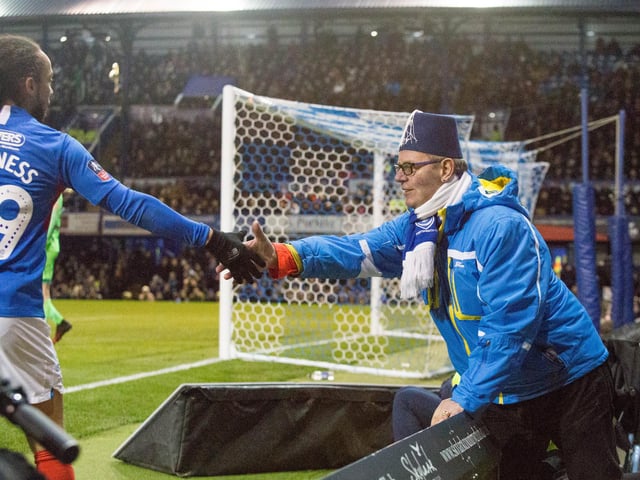 Pompey fan gets to shake hands with Marcus Harness as he comes off the pitch.