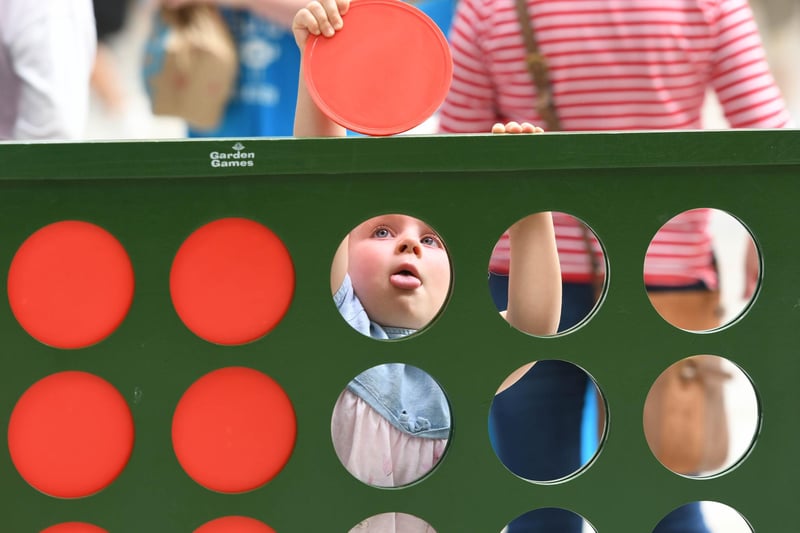 Another youngster enjoys the giant Connect 4 game.