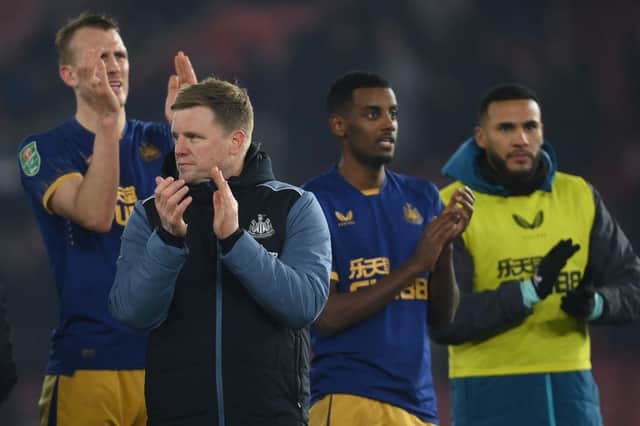 Newcastle United head coach Eddie Howe and some of his players, including Alexander Isak, applaud fans at the end of the game.