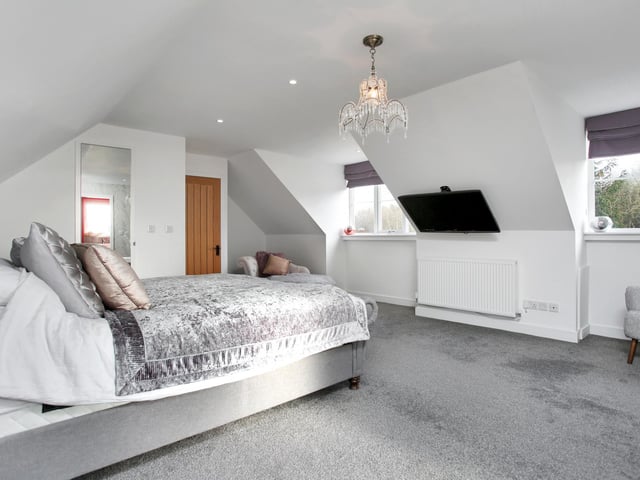 The master bedroom has an en-suite bathroom and dressing room.