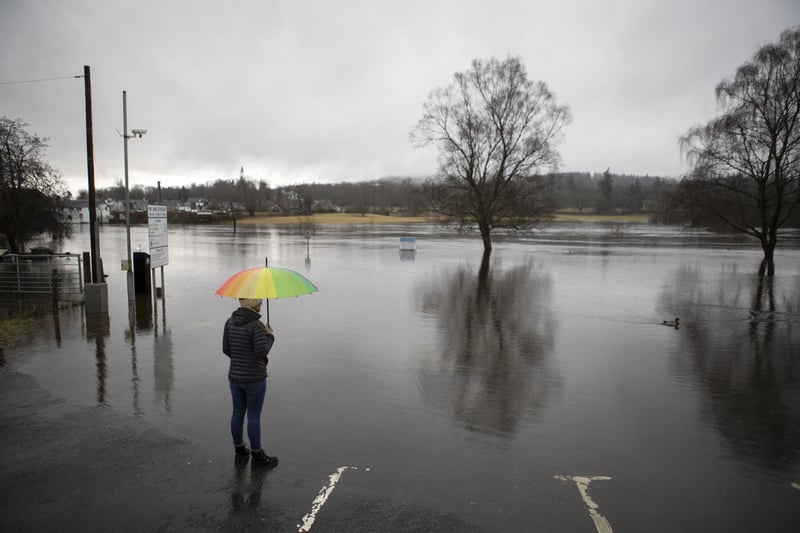 A person watches on as water levels rise.