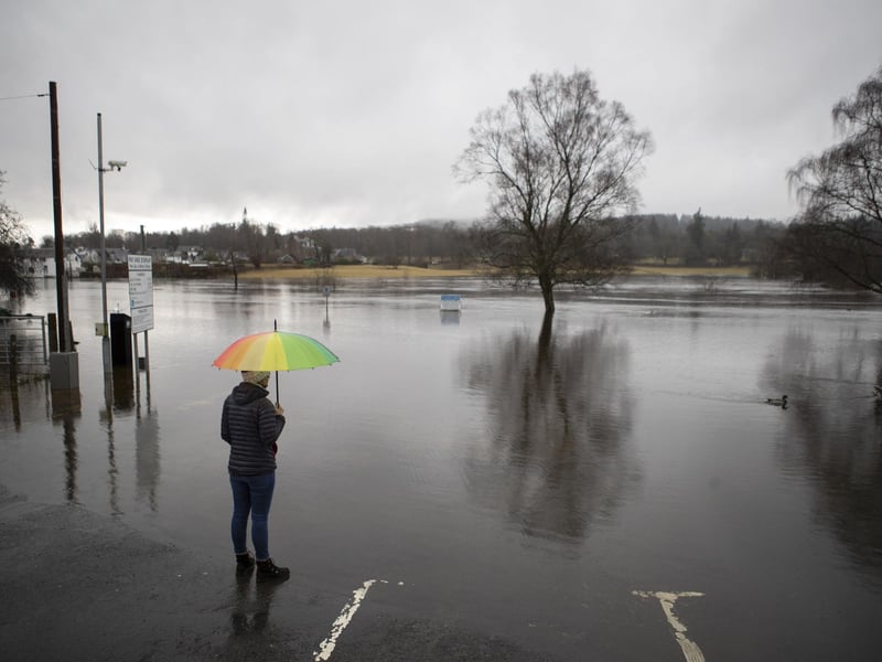 A person watches on as water levels rise.