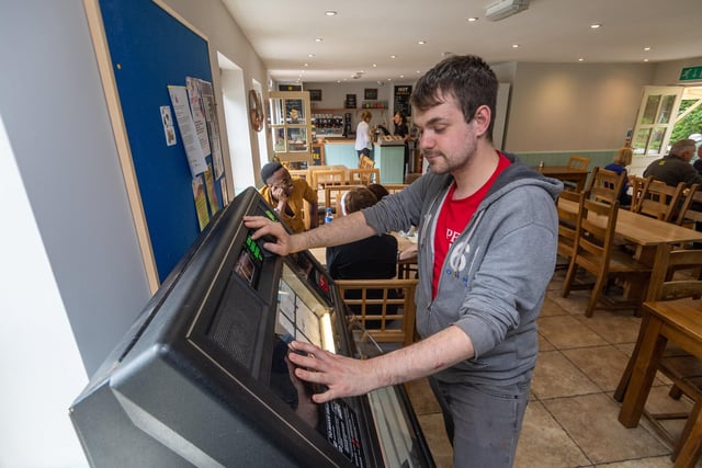 Mike Cooper, using the Jukebox in The Penny Pot Cafe, Edale, pictured in 2019