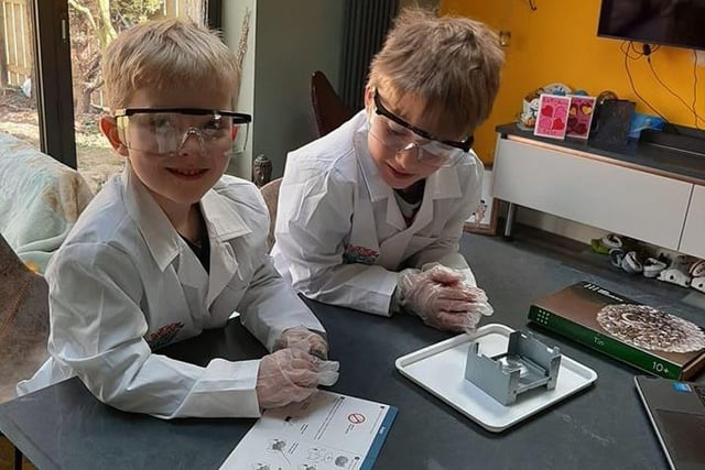 Lewis, eight, and Jack, five, wear protective clothing as part of their studies.