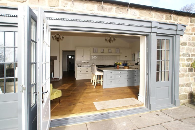 Side-aspect bi-fold doors open from the living/dining/kitchen onto the gardens, giving superb, far-reaching views.