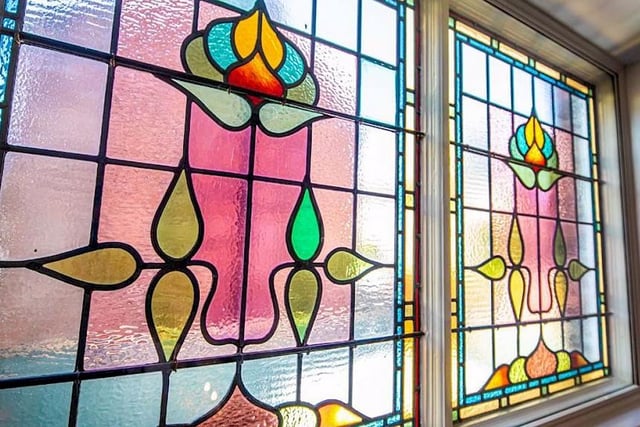 Elegant stained glass windows add to the property's charm.