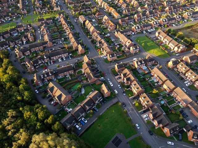 Top down aerial view of houses and streets in a residential area UK New Build Estate Agent House Prices 2022