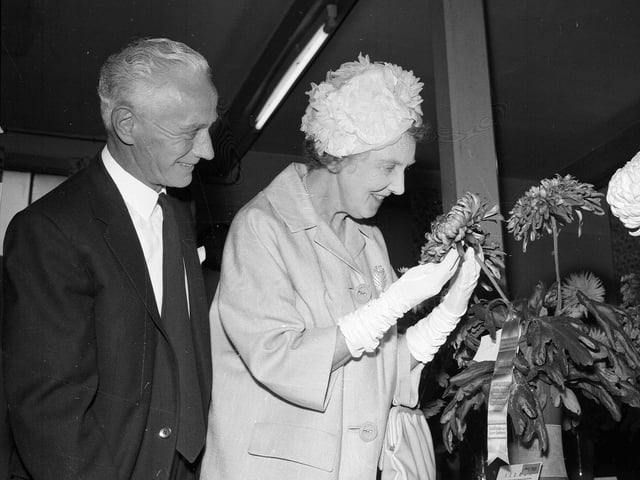 Mrs Hedderwick, the wife of a councillor, admires prize blooms with President Mr William McGregor at a flower show in Stockbridge Church Hall in September 1963.