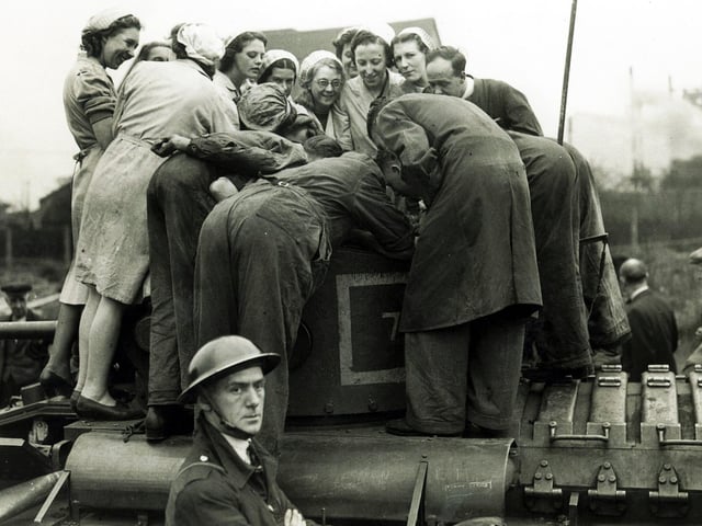 Outside Darwins in 1939 /1940. The people on the tank worked as magnet drillers, for parts which were used in the production of tanks. Irene Fothergill is first left, (smiling)