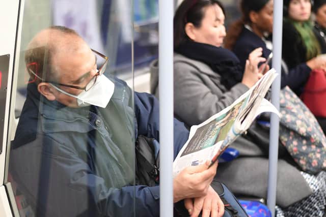 A man on the Jubilee line on the London Underground tube network wearing a protective facemask: Kirsty O'Connor/PA Wire