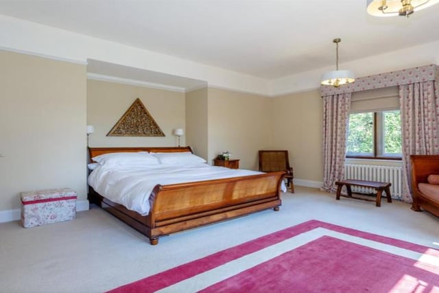 The property boasts seven bedrooms in total, spread across a split level landing on the first floor. The galleried landing leads to the principal suite, which offers an en suite bathroom as well as a dressing room.