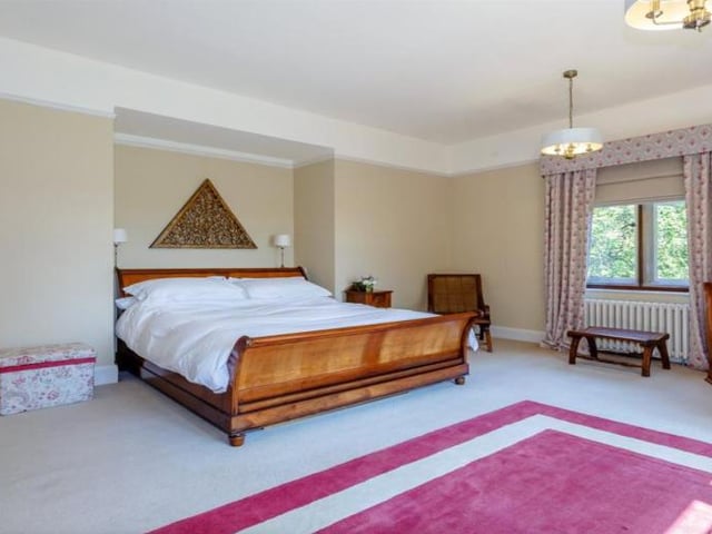The property boasts seven bedrooms in total, spread across a split level landing on the first floor. The galleried landing leads to the principal suite, which offers an en suite bathroom as well as a dressing room.