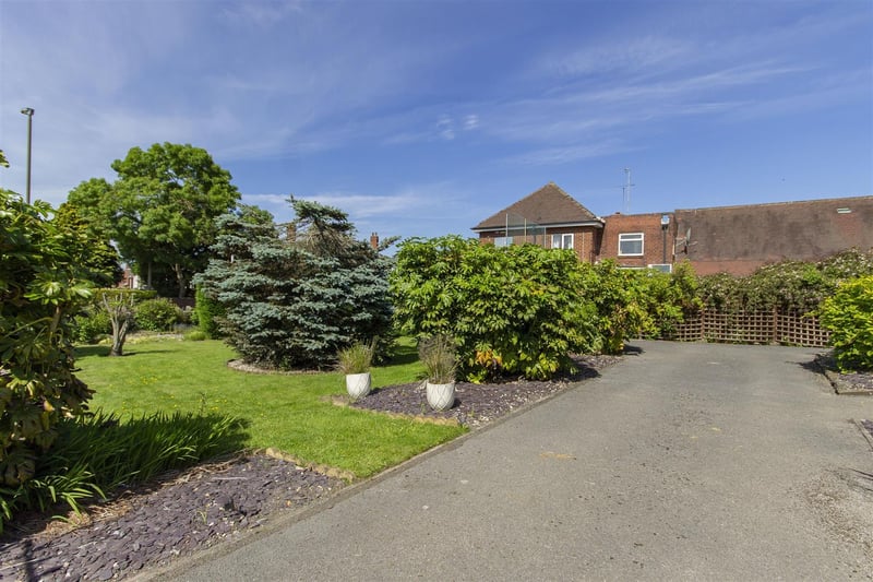 There is also a well manicured lawned garden with plum slate beds and established mature shrubs, plants and trees.