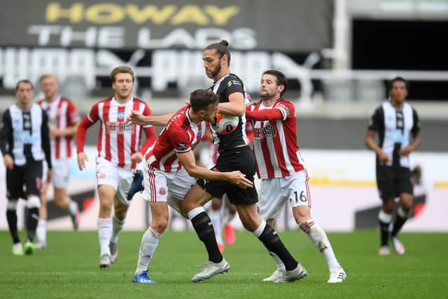 Newcastle United's Andy Carroll and Sheffield United's Oliver Norwood (right) battle for the ball during the Premier League match at St James' Park, Newcastle: Michael Regan/PA Wire/NMC Pool.