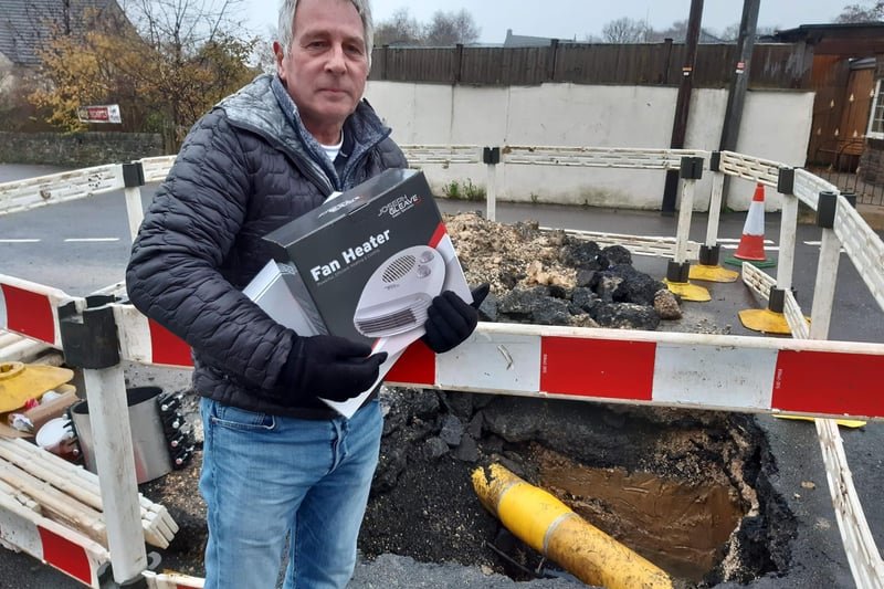Cadent Gas reportedly handed out hundreds of electric heaters to residents during repairs, as several days of freezing temperatures descended during the crisis. Here, David Turner of Hanmoor Road holds a Cadent-supplied electric heater at the site of the water leak on Bankfield Lane.