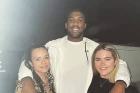Anthony Joshua poses for a photo with fans at the Tahini Lounge restaurant and cocktail bar in Dronfield