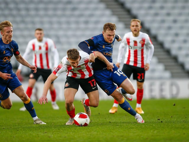 Mansfield Town midfielder George Maris fights for possession with Sunderland defender Dennis Cirkin.