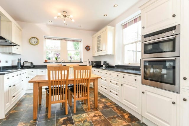 The modern kitchen has granite worktops and a large  range of integrated appliances.