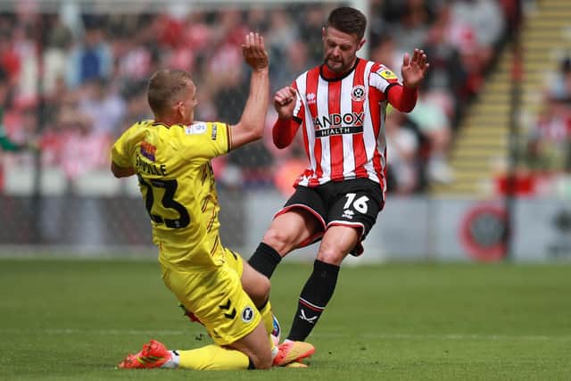 Oliver Norwood of Sheffield United is tackled by George Saville of Millwall: Simon Bellis / Sportimage