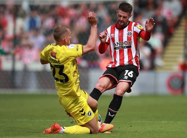 Oliver Norwood of Sheffield United is tackled by George Saville of Millwall: Simon Bellis / Sportimage