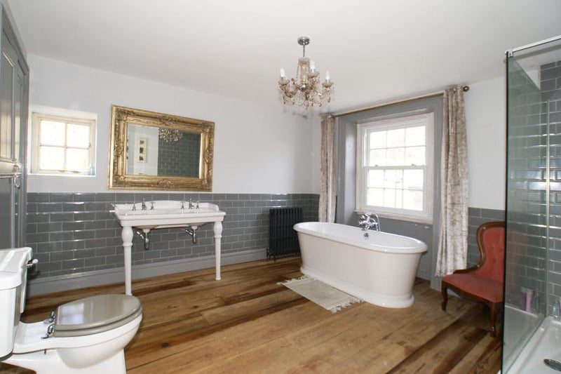 The bathroom boasts dual-aspect windows, a built-in storage cupboard and suite with: Heritage twin-bowl wash stand with mixer taps; stand-alone roll top bath with Victorian-style mixer taps and handheld shower spray; double-width shower cubicle with overhead monsoon-style mixer shower; and close-coupled WC.