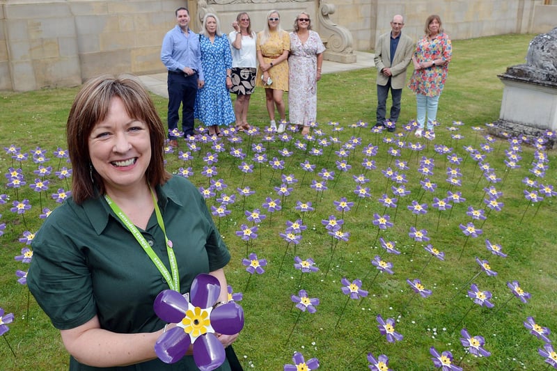 Chief executive officer at Ashgate Barbara-Anne Walker, with Ann Taylor planting a flower in memory of her brother Paul Fields and family Grace Taylor, Joss Bee, Peter Fields, Peggy Fields and Steve Griffiths planting a flower in memory of Julie Griffiths with Julie's sister Helen Shennan.