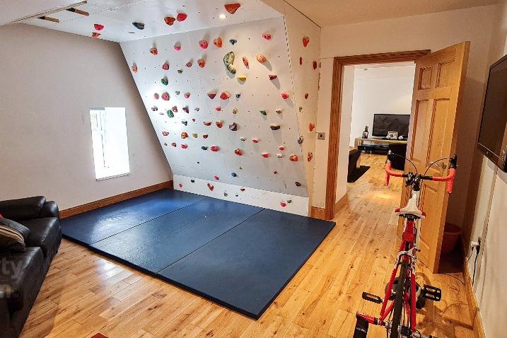 Home gym with indoor climbing wall.