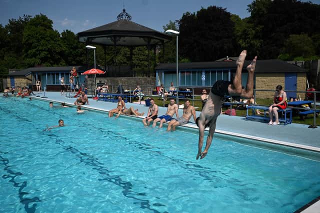 A person dives in to an outside pool at Hathersage Swimming Pool on July 18, 2022, during an extreme heat wave.