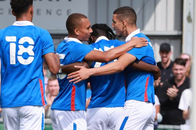 Triallist Gassan Ahadme celebrates scoring for Pompey against the Hawks with two other triallists. Picture: Paul Collins