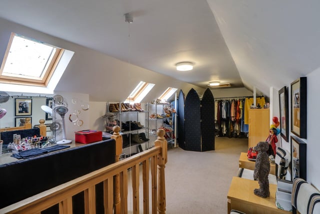 A folding staircase from the second bedroom leads up to a generously sized attic room, which is currently used for storage, but could be converted into another bedroom or sitting room.