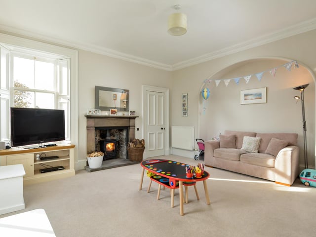 This comfortable family room, which also features and open fire, could lend itself to myriad uses