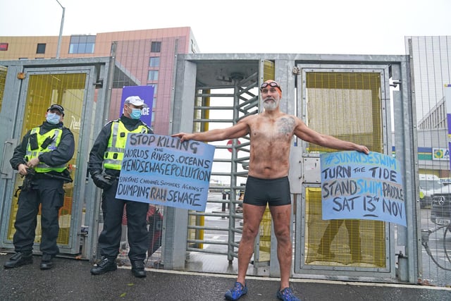 A Climate Justice Activist at the Cop26 Gates asking delegates as they make final decisions, "Are You With Us Or With Fossil Fuels?" during the official final day of the Cop26 summit in Glasgow. Picture date: Friday November 12, 2021.