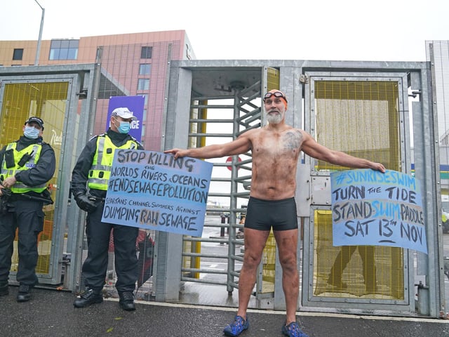 A Climate Justice Activist at the Cop26 Gates asking delegates as they make final decisions, "Are You With Us Or With Fossil Fuels?" during the official final day of the Cop26 summit in Glasgow. Picture date: Friday November 12, 2021.