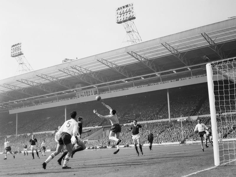 Scotland's first win at Wembley in nearly 12 years was a hard-fought British Home Championship victory engineered by two Jim Baxter goals. Here, Gordon Banks fields an Ian St John effort as England's Maurice Norman (No.5) and Scotland's Dave Mackay (right of Banks) look on