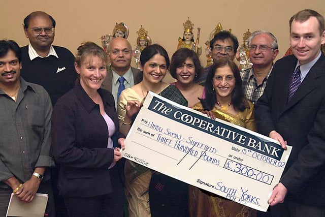 Pictured receiving a cheque for £300.00 from PC Tim Walls and Sgt Caroline Rollitt of the South Yorkshite Minorities Unit to Harsha Savani, Chairperson of HinduSamaj with Treasurer Ashwin Bha Patel and Secretaries Pushpa Venkat and Kusumben Savani with other committee members and trustees at the Ellsmere Centre Buckenham Street  back in 2002