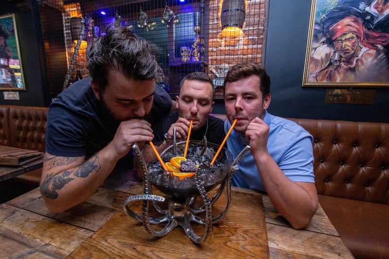 Joe Smith, Max Winslade and Curtis Bell drink one of the cocktails at Rapscallions in Southsea. Picture: Habibur Rahman