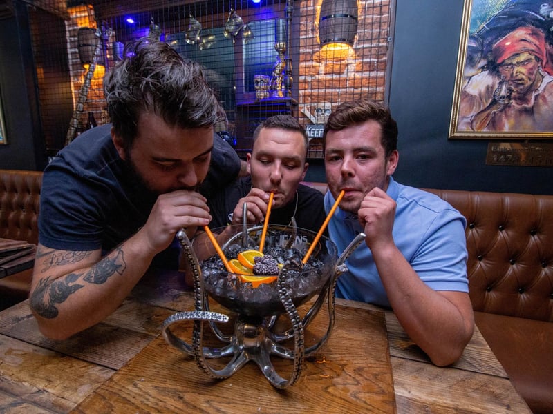 Joe Smith, Max Winslade and Curtis Bell drink one of the cocktails at Rapscallions in Southsea. Picture: Habibur Rahman