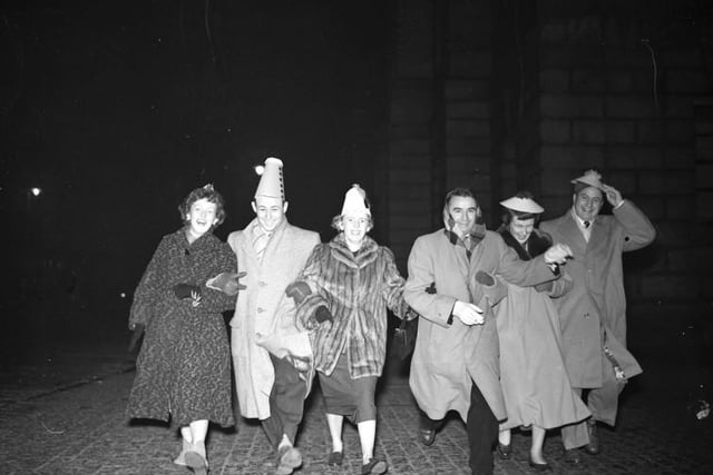 Hogmanay scene at the Tron Church as six Americans dance down the High Street.