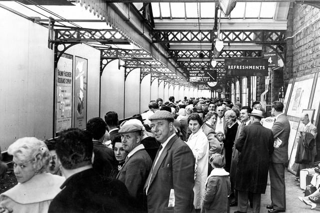 Holidaymakers wait for their train at Sheffield Victoria Station in 1962