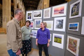Sheffield Photographic Society show at Sheffield Cathedral. Eddie Sherwood, Shirley Hollis and Emma Gittins discussing the pictures on show.