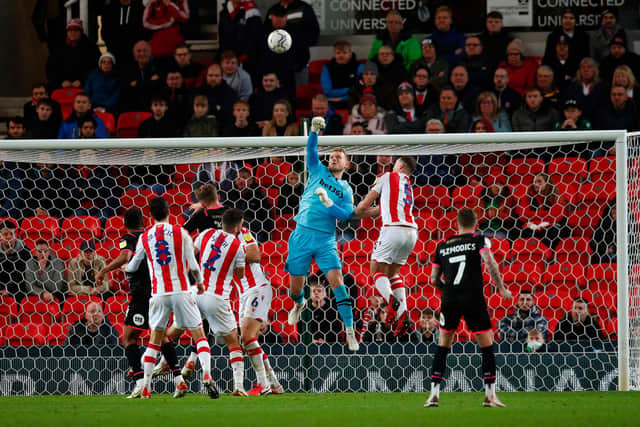 Adam Davies of Stoke City punches the ball clear during the Sky Bet Championship match between Stoke City and Peterborough United at Bet365 Stadium on November 20, 2021 in Stoke on Trent, England. (Photo by Malcolm Couzens/Getty Images)