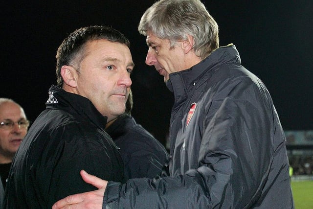 Disappointed Rovers boss Dave Penney shakes hands with Arsene Wenger.