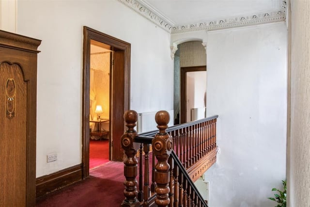 We're moving upstairs now - via the feature oak hand-carved staircase, which leads to a spacious galleried landing with high ceilings.