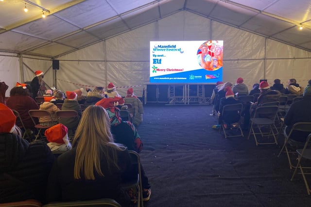 Three Christmas movies were shown on a big screen in the marquee throughout the day. Here the audience settles down to watch 'Elf', the story of Buddy, a baby who accidentally became one of Santa's elves but later set off to New York City to find his real father.