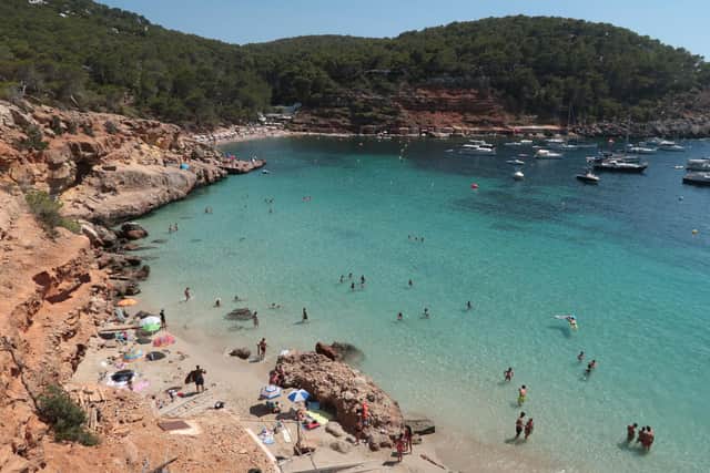 Bathers relax at Cala Saladeta beach on the island of Ibiza  (Photo by Sean Gallup/Getty Images)